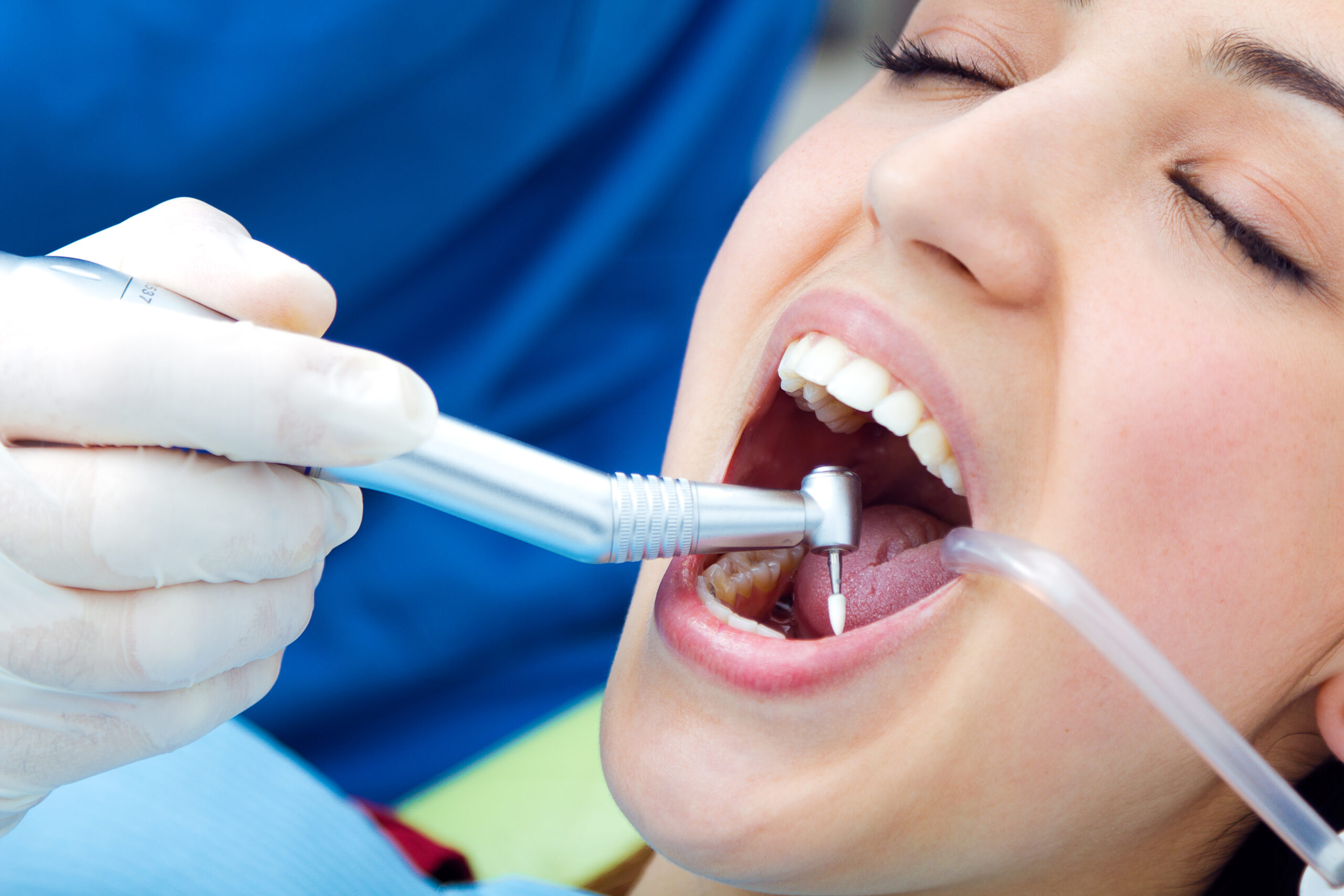 Medical scene of cute young woman at the dentist.